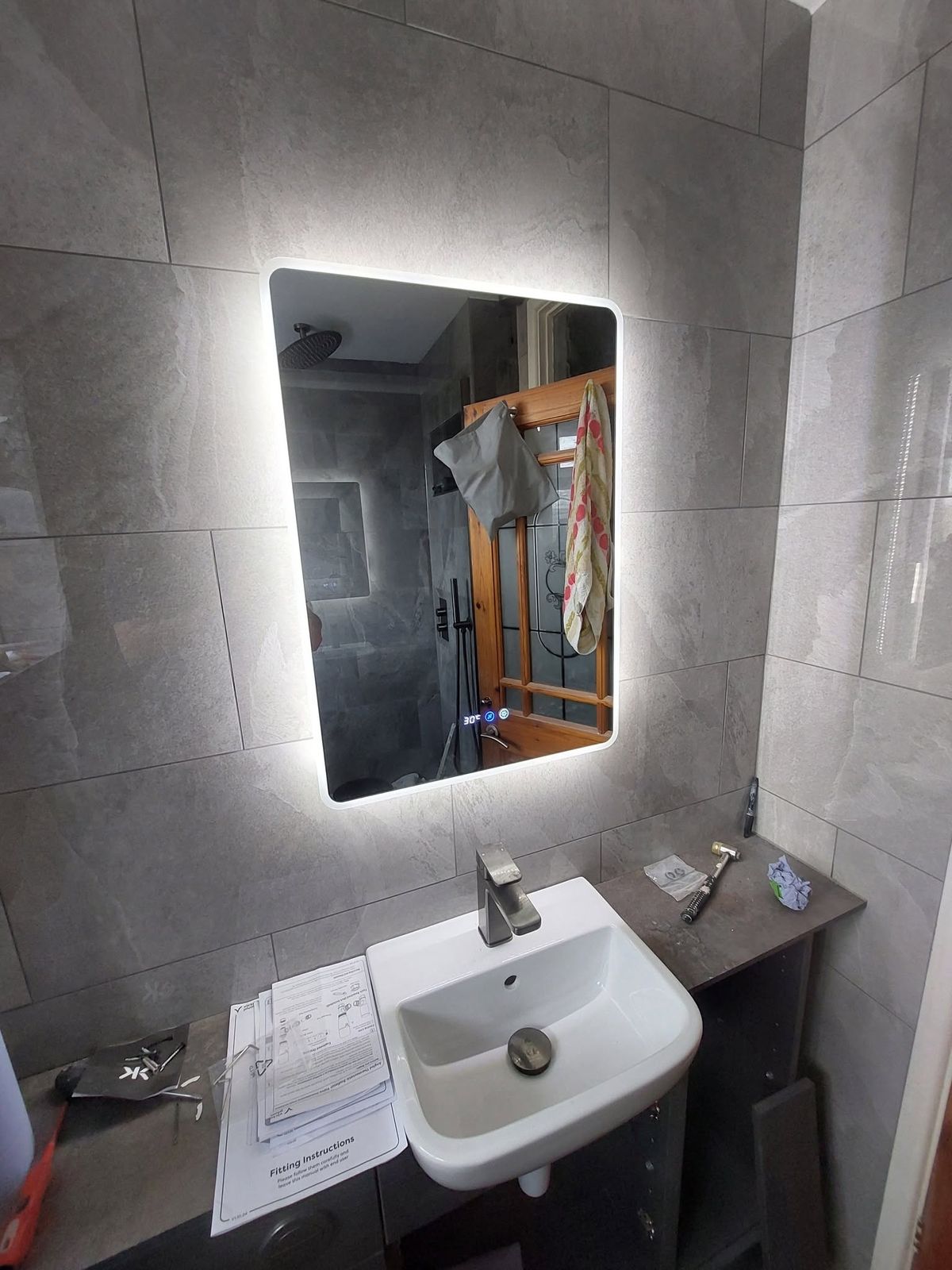 Backlit LED mirror over basin
