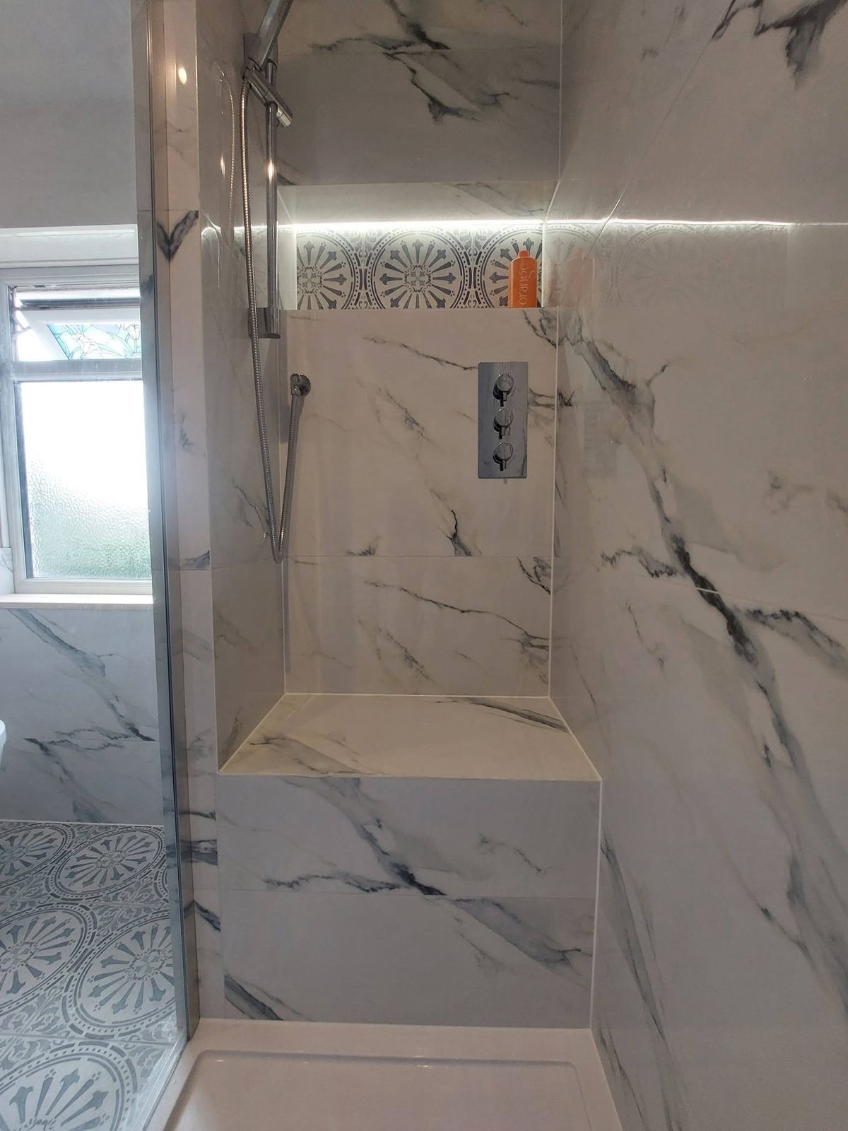 Walk-in shower with tiled bench seat and LED niche